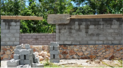 A picture of a wall being constructed with grey bricks