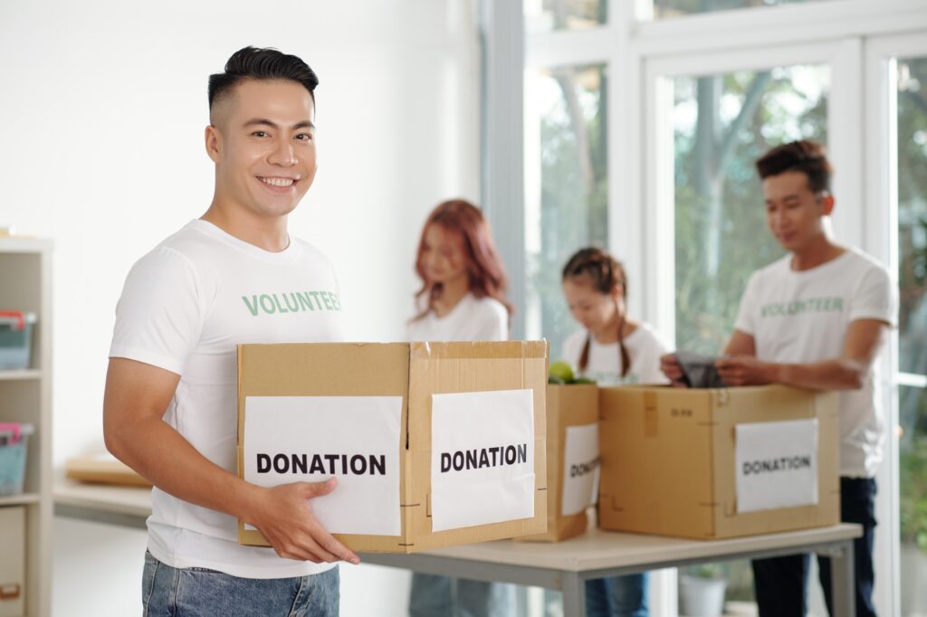 Volunteers Sorting Donated Food and Clothes