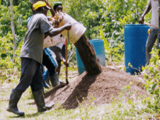 A picture of a man unloading sand from a bucket